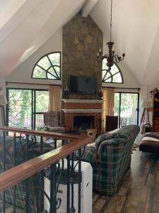 a living room with a couch and a fireplace at Casa de campo Huasca in Huasca de Ocampo