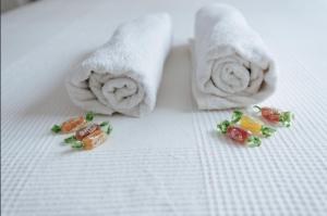two rolls of towels with candy on a table at The Best Hostelito! Free parking in Seville