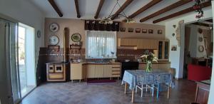 a kitchen with a table and a dining room at Casa Luce in Caltabellotta