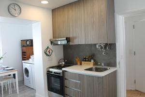 a kitchen with a sink and a stove at Madre Deus Guest House in Lisbon