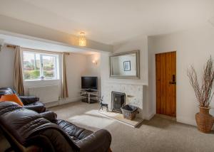 a living room with a couch and a fireplace at 60 and a half Bailgate in Lincoln