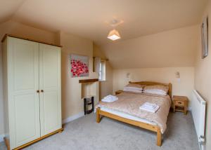 a bedroom with a bed and a closet in a room at 60 and a half Bailgate in Lincoln
