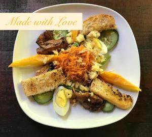 a white plate of food with vegetables and bread at Serenity Beaches Resort in Uoleva Island