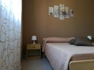 a bedroom with a bed and a window at La Gramigna Villette in Briatico