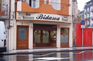 a building with a bar on a city street at Bar Pensión Restaurante Bidasoa in Irún