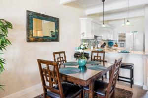 a kitchen and dining room with a table and chairs at Oceanfront Luxury Condo in Kailua-Kona
