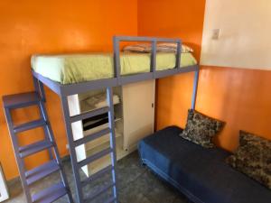 two bunk beds in a room with a bed and a ladder at Villa Crespo Arena in Buenos Aires