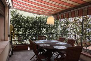 a table and chairs on a patio with a table and a ceiling at CASA-MIA Apartment in Mestre