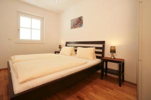 Posteľ alebo postele v izbe v ubytovaní EXCLUSIVE APARTMENTS - inclusive Zell am See-Kaprun Sommerkarte und unbegrenztem Tauern SPA Eintritt