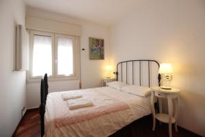 a bedroom with a bed and a table and a window at CASA-MIA Apartment in Mestre