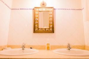 a bathroom with two sinks and a mirror at Los Chendas in Villanueva de Ávila +13 photos