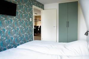 Un pat sau paturi într-o cameră la Appartement De Witte Brug