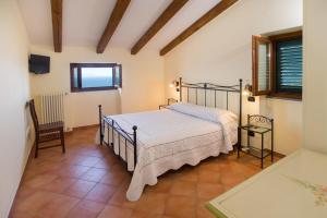 a bedroom with a bed and a chair at Il Glicine in Cetara