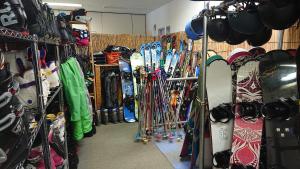 a room filled with lots of different types of skis at Hotel Oak Forest in Hakuba