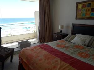a bedroom with a bed with a view of the ocean at San Alfonso del Mar Departamentos in Algarrobo