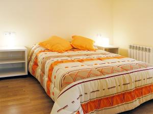 a large bed in a room with two night stands at Aparthotel Nou Vielha in Vielha