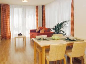 a living room with a table and a couch at Aparthotel Nou Vielha in Vielha