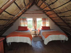 two beds in a attic room with windows at Karibu River Retreat in Marble Hall +60 photos