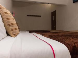 a close up of a bed in a room at Hotel Azucena in Huamantla