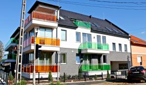 a building with colorful balconies on the side of it at Olive Apartman in Sárvár