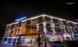 a building with a sign on the side of it at Amamas Boutique Hotel Kuching in Kuching