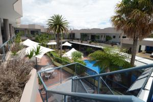 an overhead view of a resort with a pool and palm trees at Rockpool Motor Inn in South West Rocks