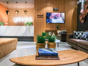 a living room with a table with a book on it at Avior Hotel in General Santos