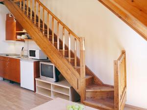 a staircase in a kitchen with a microwave and a tv at Aparthotel Nou Vielha in Vielha