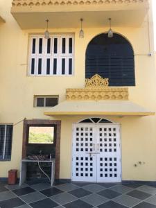 a house with a white door and a black tile floor at Jai Villa Homestay in Udaipur