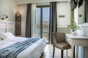 a bedroom with a bed and a desk and a window at Tourist Boutique Hotel in Argostoli