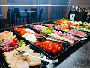 a tray of different types of food on a table at Jet Hotel Zurich Airport in Rümlang