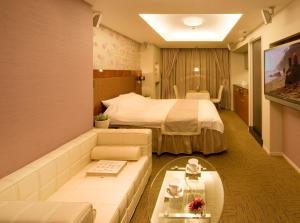 Ein Bett oder Betten in einem Zimmer der Unterkunft Carrot ISE (Adult Only)