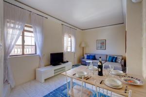 a living room with a table and a couch at Traditional Maltese Townhouse, Roof Terrace and Views in Senglea