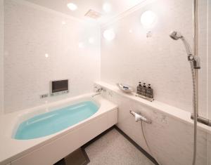 a bathroom with a tub and a shower at Carrot ISE (Adult Only) in Ise
