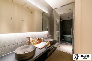 a bathroom with two sinks and a large mirror at Konjaku-So Osaka Castle South in Osaka