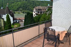 a table and chairs on a balcony with a view at Da Carla in Rüdesheim am Rhein