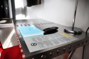 a table with a book and a remote control on it at Comfort Hotel Grand Central in Oslo