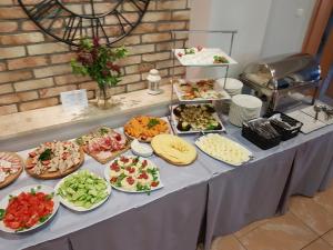 a table with many plates of food on it at Sosnowe Zacisze in Białystok