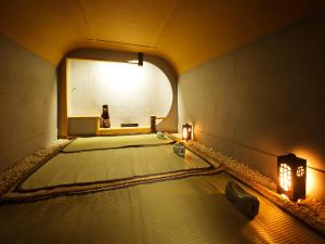 an empty yoga room with a mirror and lights at Heihachi Tea House Inn in Kyoto