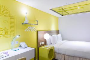 Postel nebo postele na pokoji v ubytování Green World Hotel - Zhonghua