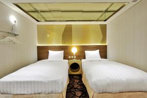 Postel nebo postele na pokoji v ubytování Green World Hotel - Zhonghua