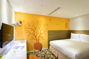 Postel nebo postele na pokoji v ubytování Green World Hotel - Zhonghua