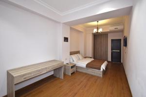 a bedroom with a bed and a bench in it at Luxury apartments just near Republic Square in Yerevan