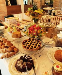 a table filled with different types of pastries and pies at Locanda Rabaya' in Barbaresco