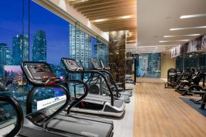 a gym with treadmills and a view of a city at Hotel Nikko Bangkok - SHA Extra Plus Certified in Bangkok