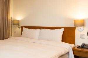 Postel nebo postele na pokoji v ubytování Bowa Hotel Penghu + 31 fotografií