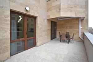 a patio with a table and chairs in a building at Luxury apartments just near Republic Square in Yerevan