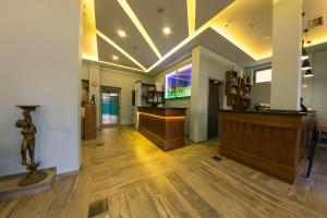 a lobby with a bar in a building at Pandora Residence Apartments in Tirana