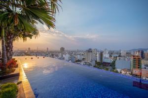 a swimming pool on top of a building with a city at SEA QUEEN Hotel in Da Nang