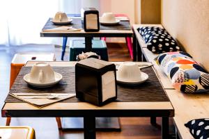 a group of tables with plates and utensils on them at TRAVEL STATION Bedandbreakfast in Bari